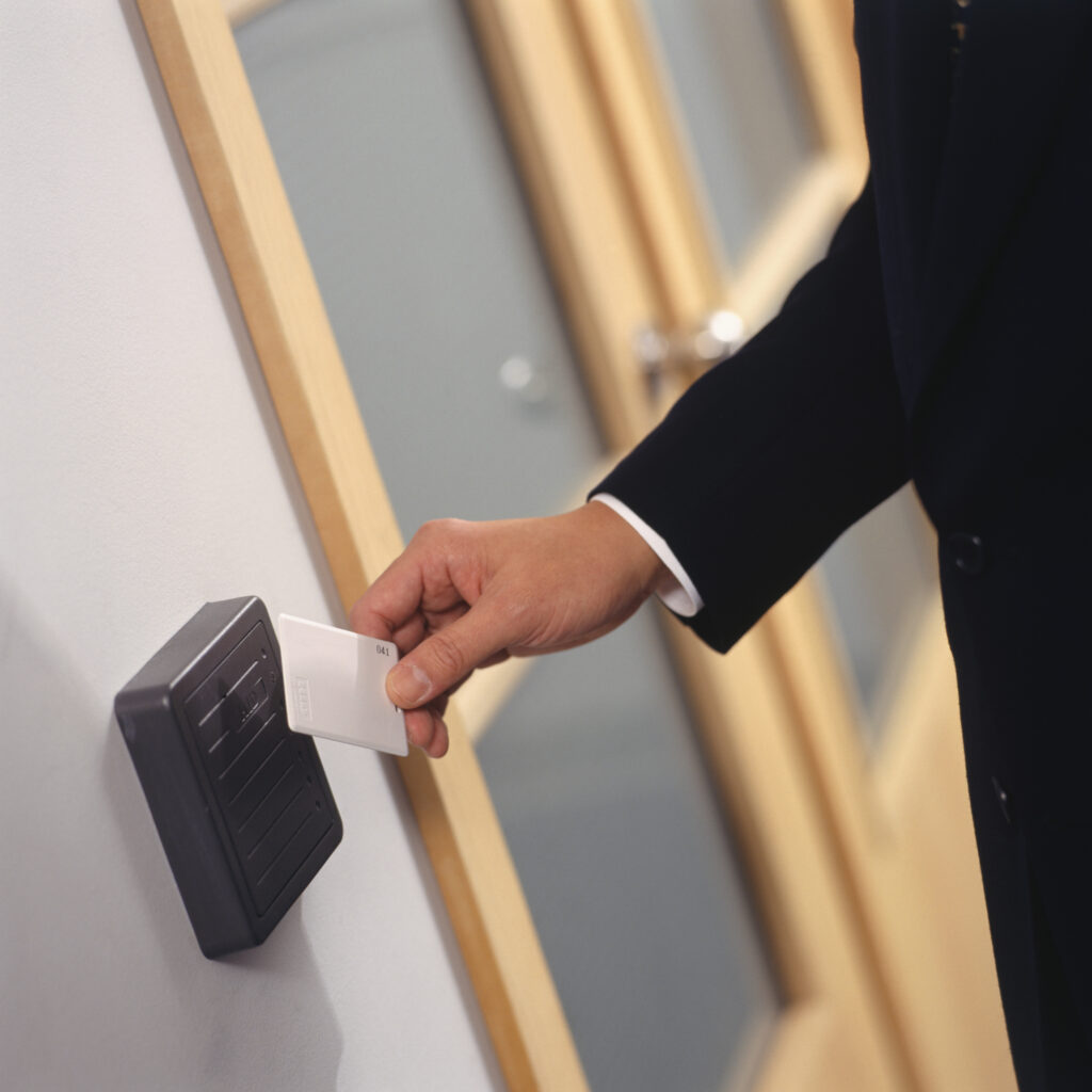 business man badging into secured door; demonstrates the Wiegand effect